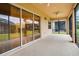 Screened porch with sliding glass doors and view of backyard at 4568 Back Nine Dr, Winter Haven, FL 33884