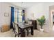 Dining area with dark wood table and blue curtains at 6421 Alamanda Hills Dr, Lakeland, FL 33813