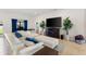 Living area with white sectional sofa and an electric fireplace at 6421 Alamanda Hills Dr, Lakeland, FL 33813
