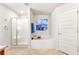 Spa-like bathroom featuring a soaking tub, shower, and stylish tile at 6421 Alamanda Hills Dr, Lakeland, FL 33813