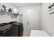 Convenient laundry room with washer, dryer, and storage shelves at 6421 Alamanda Hills Dr, Lakeland, FL 33813