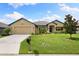 Front view of a single-Gathering house with a two-car garage and landscaped lawn at 6421 Alamanda Hills Dr, Lakeland, FL 33813