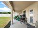 Covered patio with table, chairs, and grill at 6421 Alamanda Hills Dr, Lakeland, FL 33813