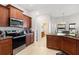 Modern kitchen with stainless steel appliances and wood cabinets at 6421 Alamanda Hills Dr, Lakeland, FL 33813