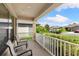 Covered front porch with seating area, overlooking the street at 6421 Alamanda Hills Dr, Lakeland, FL 33813
