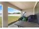 Covered patio with table, chairs, and lawn tractor at 6421 Alamanda Hills Dr, Lakeland, FL 33813