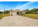 Front view of a ranch-style home with a large driveway at 329 N 19Th St, Haines City, FL 33844