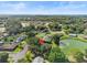 Aerial view of a house nestled in a tree-lined residential neighborhood by a lake at 3245 Cross Fox Dr, Mulberry, FL 33860