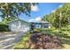 Light blue house with white garage doors and well-maintained lawn at 3245 Cross Fox Dr, Mulberry, FL 33860