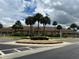 Community clubhouse with palm trees and fountain at 657 Sweetwater Way, Haines City, FL 33844