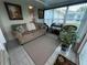 Bright sunroom featuring a couch and wicker chair at 657 Sweetwater Way, Haines City, FL 33844