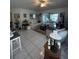 Spacious living room with light colored furniture and adjacent dining area at 657 Sweetwater Way, Haines City, FL 33844