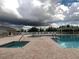 Community pool and spa with lounge chairs at 657 Sweetwater Way, Haines City, FL 33844