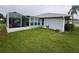 Home with screened patio and grassy backyard at 657 Sweetwater Way, Haines City, FL 33844