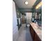Bathroom with tub shower and marble vanity at 657 Sweetwater Way, Haines City, FL 33844
