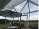 Sunroom with table and chairs, overlooking the backyard at 657 Sweetwater Way, Haines City, FL 33844