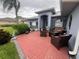 Brick patio with seating area and landscaping at 657 Sweetwater Way, Haines City, FL 33844