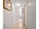 Clean hallway with tile floors leading to bathroom at 4353 Dinner Lake Dr, Lake Wales, FL 33859