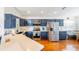 Modern kitchen with blue cabinets, stainless steel appliances, and white countertops at 4353 Dinner Lake Dr, Lake Wales, FL 33859