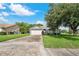 Single-story house featuring a two-car garage and well-maintained lawn at 4353 Dinner Lake Dr, Lake Wales, FL 33859