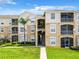 Two-story condo building with balconies and landscaping at 8105 Coconut Palm Way # 204, Kissimmee, FL 34747