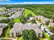 Aerial view of apartment buildings, parking lots, and surrounding landscape at 8105 Coconut Palm Way # 204, Kissimmee, FL 34747
