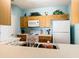 Kitchen with wood cabinets, white appliances, and a double sink at 8105 Coconut Palm Way # 204, Kissimmee, FL 34747