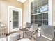 Private patio with seating and a glass-top table at 8105 Coconut Palm Way # 204, Kissimmee, FL 34747