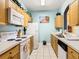 Bright kitchen with wood cabinets, white appliances, and light blue walls at 8105 Coconut Palm Way # 204, Kissimmee, FL 34747