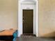 Apartment entryway with a dark brown door and a small rug at 8105 Coconut Palm Way # 204, Kissimmee, FL 34747
