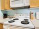 Close-up of a four-burner electric cooktop at 8105 Coconut Palm Way # 204, Kissimmee, FL 34747