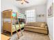 Bedroom with a bunk bed, sofa, and window with blinds at 8105 Coconut Palm Way # 204, Kissimmee, FL 34747