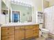 Clean bathroom with wood vanity, shower, and toilet at 8105 Coconut Palm Way # 204, Kissimmee, FL 34747