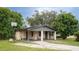 Brick home with covered porch, mature landscaping, and a basketball hoop at 2920 Gause St, Bartow, FL 33830