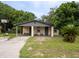Brick home with covered porch, mature landscaping, and a basketball hoop at 2920 Gause St, Bartow, FL 33830