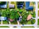 Aerial view of house with solar panels, surrounded by trees at 2920 Gause St, Bartow, FL 33830