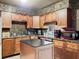 Modern kitchen with wood cabinets, granite countertops, and island at 2920 Gause St, Bartow, FL 33830