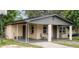 Brick home with covered porch, mature landscaping, and a basketball hoop at 2920 Gause St, Bartow, FL 33830