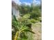 Landscaped backyard with lush greenery at 400 El Camino Dr # 223, Winter Haven, FL 33884