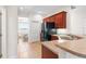 Kitchen with wood cabinets, black appliances, and a breakfast bar at 192 Viola Dr, Auburndale, FL 33823
