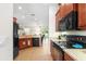 Well-equipped kitchen featuring wood cabinets, black appliances, and ample counter space at 192 Viola Dr, Auburndale, FL 33823