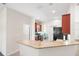 Modern kitchen with dark wood cabinets, granite counters, and black appliances at 192 Viola Dr, Auburndale, FL 33823