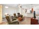 Spacious living room with hardwood floors, comfortable seating, and kitchen access at 192 Viola Dr, Auburndale, FL 33823