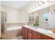 Bathroom with double vanity, soaking tub, and shower at 192 Viola Dr, Auburndale, FL 33823