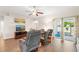 Bright living room with hardwood floors, comfy seating, and sliding glass doors leading to a patio at 192 Viola Dr, Auburndale, FL 33823