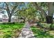 Park pathway under large shade trees at 192 Viola Dr, Auburndale, FL 33823