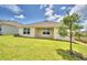 Backyard view showing covered patio and lawn at 1234 Tagliamento Ln, Haines City, FL 33844