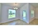 Bright dining room with chandelier and access to backyard at 1234 Tagliamento Ln, Haines City, FL 33844