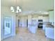 Open concept kitchen and dining area with island and chandelier at 1234 Tagliamento Ln, Haines City, FL 33844