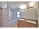 Bathroom with double sinks, granite countertop, and a bathtub at 1269 Tagliamento Ln, Haines City, FL 33844